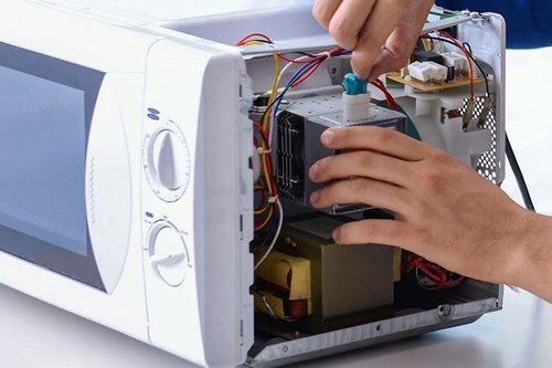 Technician checking microwave components